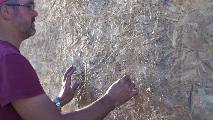 Adult man making marks on the wall. Pencil in hand. Construction works. Countryside plot Open. Close-up. Real time.
