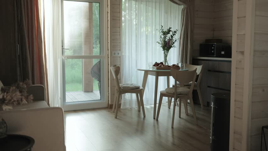 A Cozy and Modern Dining Space Abounding with Bright Natural Light and Inviting Atmosphere