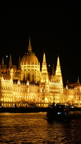 An aerial view shows a majestic building in Budapest illuminated at night