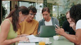 Multiracial group of young teenage students or hipster friends meeting for lunch in cafe, prepare for classes and exams, have conversation over cup of coffee. Education concept, modern students - Powered by Shutterstock - Get 15% off with code: PIKWIZARD15