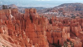 Discover the breathtaking landscapes of Bryce Canyon featuring dramatic red rock formations, towering cliffs, and vast vistas under a clear blue sky. - Powered by Shutterstock - Get 15% off with code: PIKWIZARD15