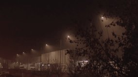 Foggy night industrial warehouse building illuminated by street lighting. mysterious and atmospheric industrial design - Powered by Shutterstock - Get 15% off with code: PIKWIZARD15