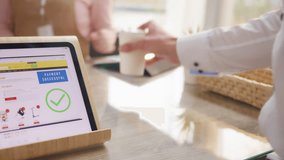 Paying cashless at counter, using biometric facial recognition close up. Digital tablet financial app scanning customer face, showing successful payment notification on screen - Powered by Shutterstock - Get 15% off with code: PIKWIZARD15