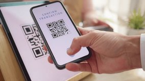 Man scanning qr code, paying with smartphone closeup. Successful electronic payment. Digital money transaction system at store counter - Powered by Shutterstock - Get 15% off with code: PIKWIZARD15
