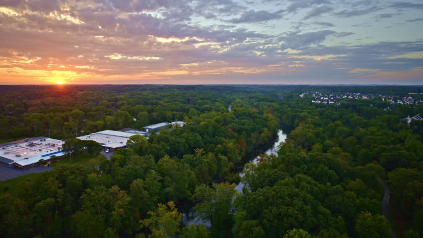 A high-flying drone captures summer scenes over the Huron River en route to Ypsilanti, Michigan.