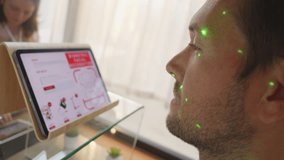 Caucasian man scanning face while making contactless payment close up. Biometric facial verification approving transaction at shop counter - Powered by Shutterstock - Get 15% off with code: PIKWIZARD15