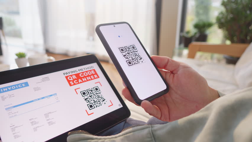 Woman scanning invoice qr code and confirming with fingerprint for online payment. Paying and approving identity with secure biometric technology