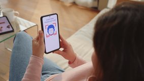 Woman completing contactless payment by scanning face on smartphone screen, over shoulder view. Identity and financial secure data protection technology - Powered by Shutterstock - Get 15% off with code: PIKWIZARD15