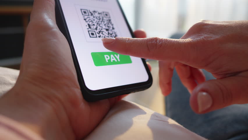 Woman confirming online qr code payment on smartphone close up. Hand clicking pay button on mobile screen. Cashless digital transaction concept - Powered by Shutterstock - Get 15% off with code: PIKWIZARD15