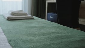 Female hands in a hotel room lay out fresh and clean towels for guests. Hotel service, maid prepares the room for travelers to check in. Hospitality - Powered by Shutterstock - Get 15% off with code: PIKWIZARD15