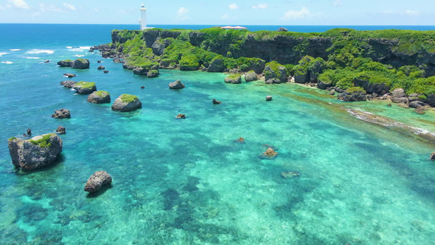 Cinematic aerial flyover of Hennasaki Lighthouse in Miyakojima Island in Okinawa, Japan