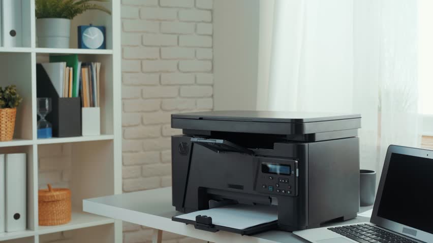 A woman prepares to print important documents in a modern office setting during the afternoon hours