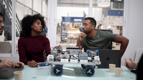 Multiracial team of engineers testing a robotics prototype in modern factory, discussing and collaborating on innovative technology - Powered by Shutterstock - Get 15% off with code: PIKWIZARD15
