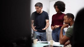 Diverse engineers collaborate on robotics project in modern factory, fostering innovation and teamwork - Powered by Shutterstock - Get 15% off with code: PIKWIZARD15