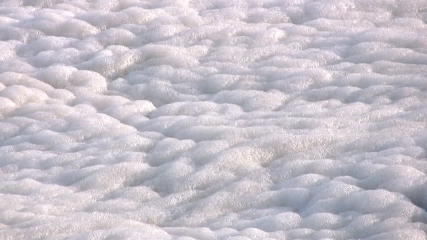 Surf made a lot of foam. This foam is very colorful ripples on the sea waves