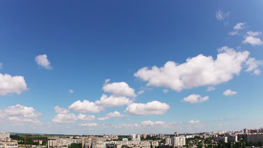 Summer. Sunshine and blue sky. The small city. Clouds and shadows of clouds are