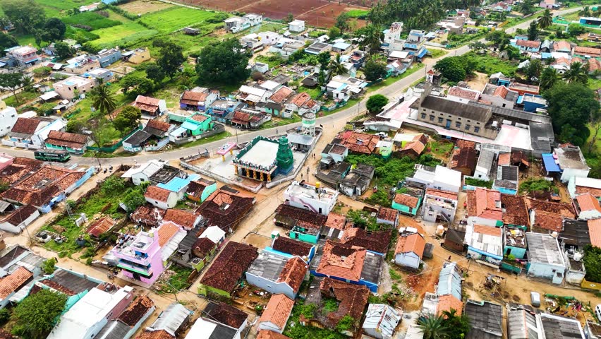 Aerial view of Gumatapura village in Karnataka during the Cow Dung Festival, showcasing a vibrant rural settlement, traditional houses, and cultural festivities from above.