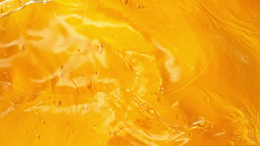 Super Slow Motion Shot of Golden Oil Waving in Water at 1000fps.