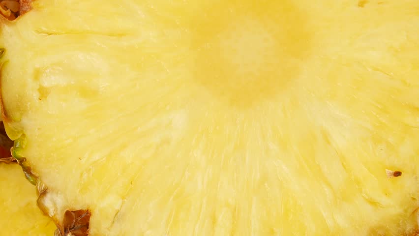 Freshly sliced pineapple on a plate.