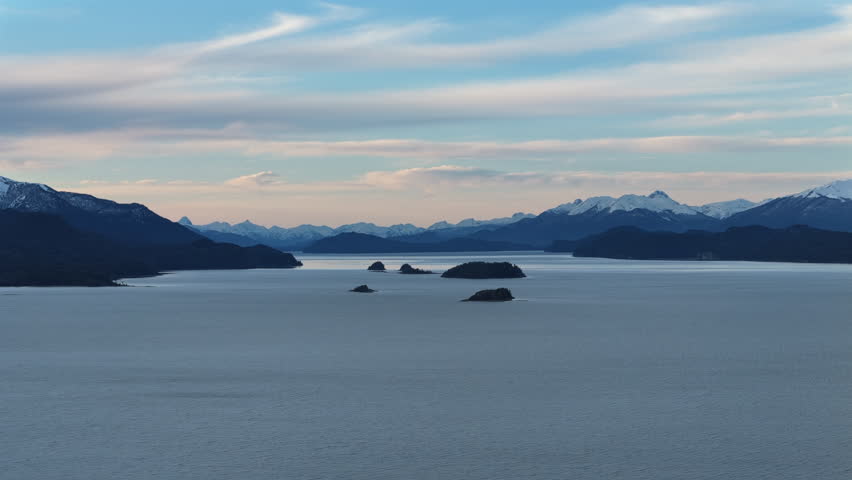Aerial view of lake nahuel huapi in patagonia, argentina, with expansive waters and distant mountains under a serene sky, capturing the natural beauty of this iconic south american destination