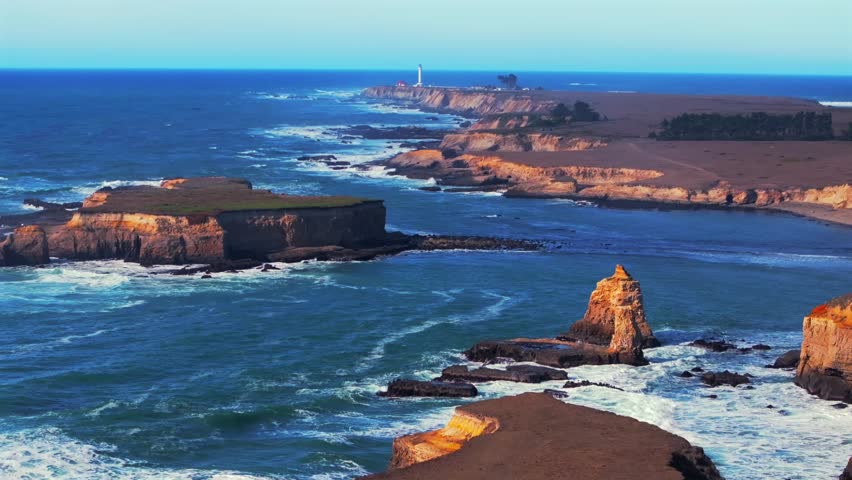 Sunny daytime Mendocino coast islands Point Arena Rock Lighthouse aerial drone view California rugged coastline wave swell rocky Rocas Fort Bragg San Fran Northern Pacific Ocean Coastal forward up