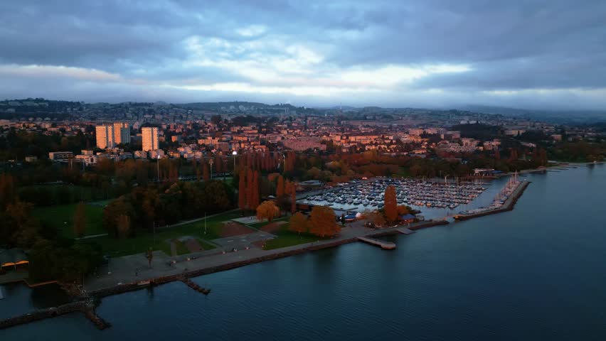 Pan drone shot of Port of Vidy and Lausanne at sunset in Canton of Vaud Switzerland