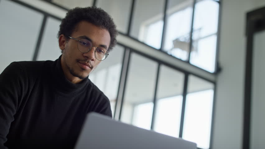 Focused Young Professional Using Laptop in Modern Office - Powered by Shutterstock - Get 15% off with code: PIKWIZARD15
