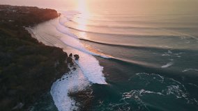 Coastline landscape with perfect ocean waves with warm sunset in Bali. Swell lines on Padang Padang. Aerial view - Powered by Shutterstock - Get 15% off with code: PIKWIZARD15