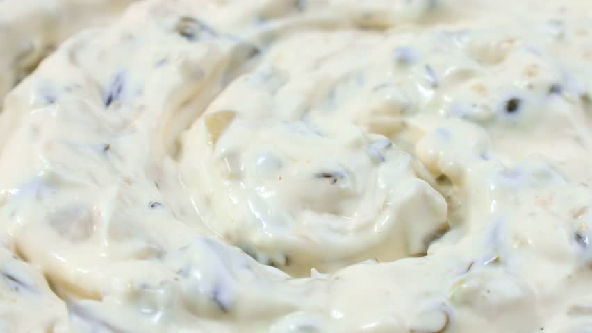 Tartar sauce with onions and pickled cucumbers circle rotation close up