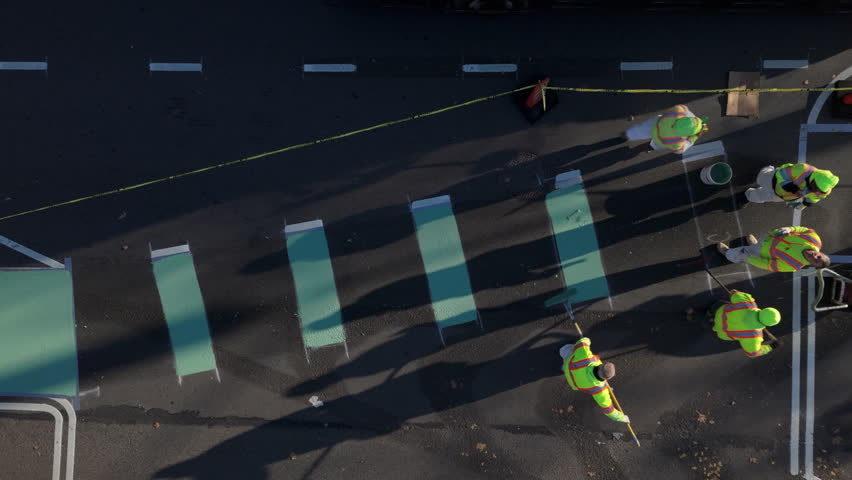 overhead view workers painting striped bike lane on McGuinness Blvd in Brooklyn