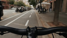 Pov riding bicycle bike, point of view closeup of a hand on a bicycle handle a sunny day, highlighting the joy of cycling in spain, barcelona - Powered by Shutterstock - Get 15% off with code: PIKWIZARD15