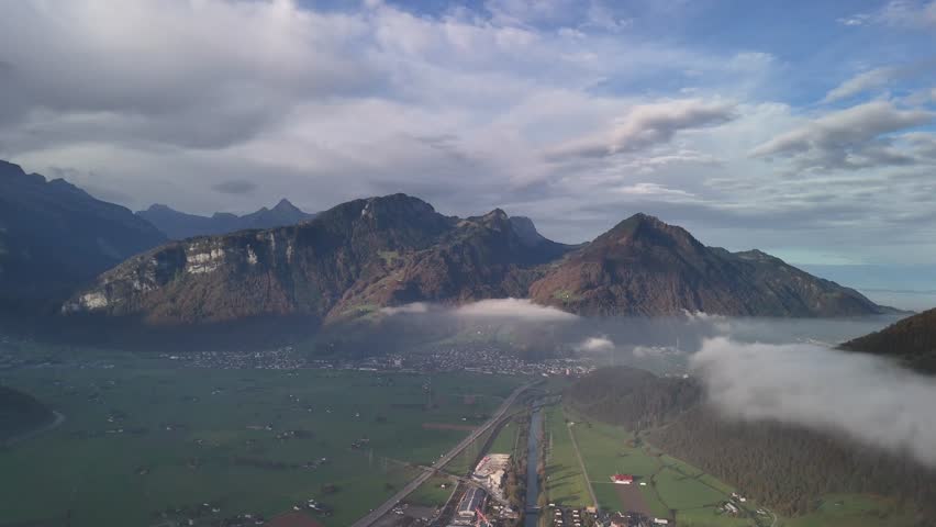 Switzerland nature mountains Alps alpine region, aerial above clouds filled valley