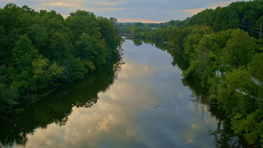 Aerial drone view of the mist-covered Huron River running near Ann Arbor, Michigan.