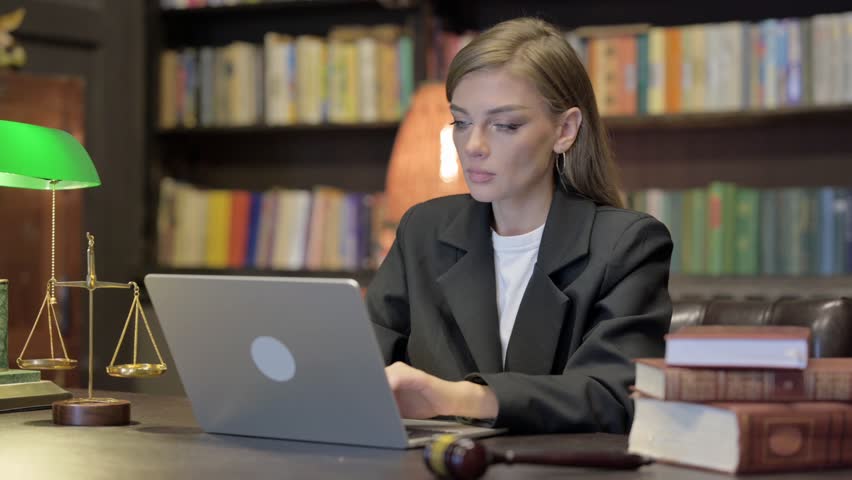 Female Lawyer Looking at Camera with Laptop