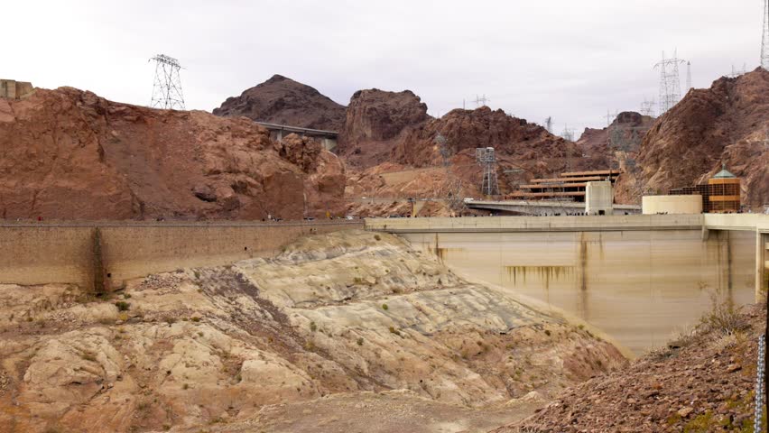 White Sign Reading Danger Hazardous Area is Seen with A Stunning Panning View of The Hoover Dam in the Background