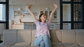 Joyful model falling couch looking around with smile at home. Carefree happy woman enjoying weekend feeling relaxed. Positive lazy lady spending free time at apartment interior. Domestic lifestyle  - Powered by Shutterstock - Get 15% off with code: PIKWIZARD15
