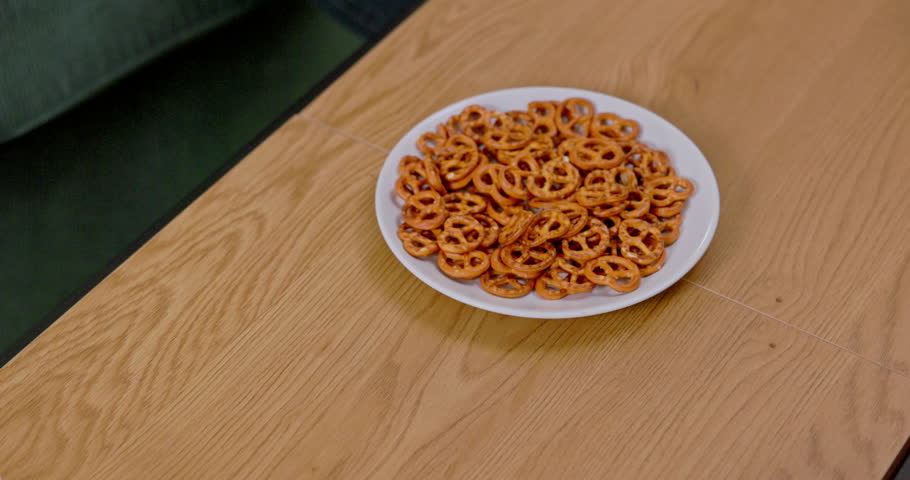 A Platter filled with Crunchy Pretzels beautifully arranged on a Rustic Wooden Table