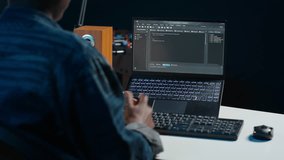 Software developer writes code on laptop screen while in apartment office using Java programming languages. Programmer remotely working on fixing database errors while working from home, camera A - Powered by Shutterstock - Get 15% off with code: PIKWIZARD15