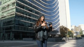 Young woman is dancing in the street, enjoying music on her headphones - Powered by Shutterstock - Get 15% off with code: PIKWIZARD15