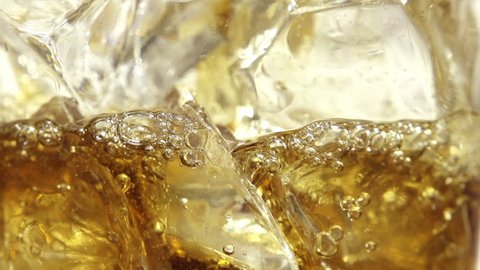 Close up view of the ice cubes in cola background