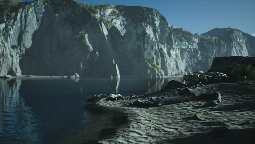 A serene view of rugged cliffs towering over calm waters in Australia during early morning light. The landscape features rocky shores, lush greenery, and tranquil reflections.