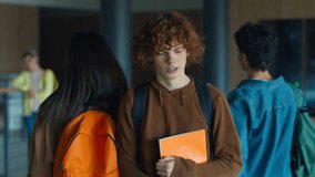 Sad upset stressed bullied Caucasian man male guy student pupil schoolboy walking going in school academy corridor aggressive bullying students girl boy push hit shoulder bully physical mock problem - Powered by Shutterstock - Get 15% off with code: PIKWIZARD15