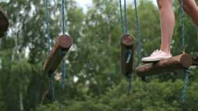 Close-up of a woman's legs running an obstacle course along parallel unstable bars in a rope park. - Powered by Shutterstock - Get 15% off with code: PIKWIZARD15