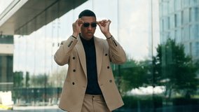 Happy funny fooling having fun African American businessman business man male guy turning around spin rotate put on sunglasses black glasses stylish fashion walking in city downtown office building - Powered by Shutterstock - Get 15% off with code: PIKWIZARD15
