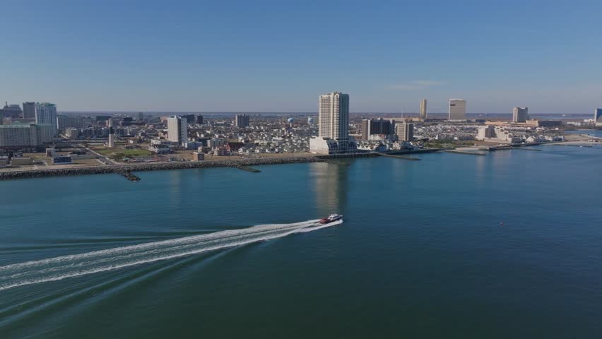 Aerial Drone Footage Of Atlantic City New Jersey On a Perfect Clear Blue Sky Day with No People Ocean Boats Towers Skyscrapers Sunny Epic Viral Cityscape no Traffic Clean Neutral Color