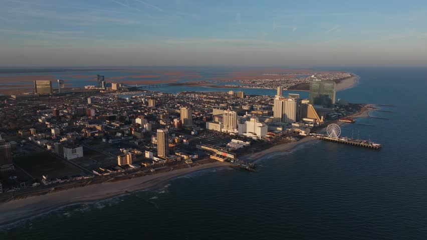 Aerial Drone Footage Of Atlantic City New Jersey On a Perfect Clear Blue Sky Day with No People Ocean Boats Towers Skyscrapers Sunny Epic Viral Cityscape no Traffic Clean Neutral Color