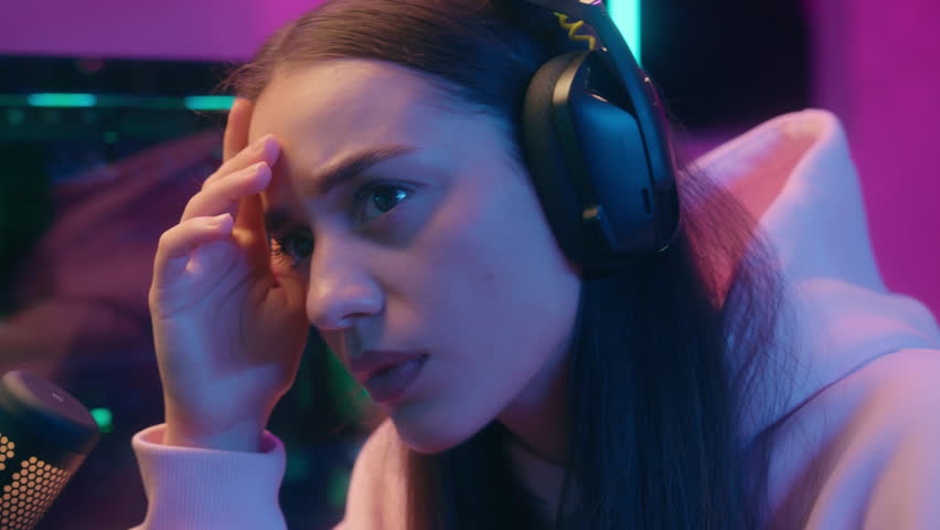 Upset sad frustrated Caucasian woman girl female streamer gamer influencer in headphones streaming problem lost loose failure stress bad news computer stream online video gaming play game lose night