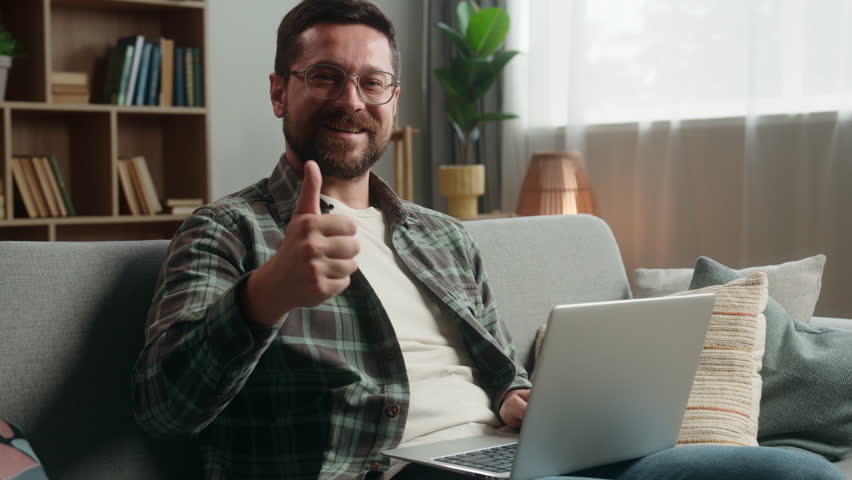 Caucasian man male freelancer businessman business guy online shopping laptop computer working distant work internet pc browsing net web showing thumb up recommend satisfied happy gesture at home