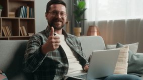 Caucasian man male freelancer businessman business guy online shopping laptop computer working distant work internet pc browsing net web showing thumb up recommend satisfied happy gesture at home - Powered by Shutterstock - Get 15% off with code: PIKWIZARD15