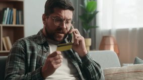 Stressed irritated annoyed angry Caucasian man male guy shopping online problem talking call support help bank service talk argue conflict mobile phone smartphone blocked credit bank card at home - Powered by Shutterstock - Get 15% off with code: PIKWIZARD15